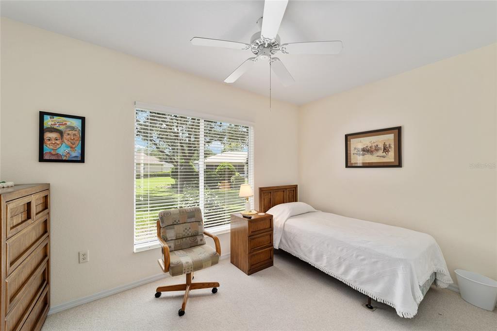 12896 Southeast 91st Terrace Road Summerfield, FL 34491 - Photo 34 of 77 a bedroom with a bed and a large window