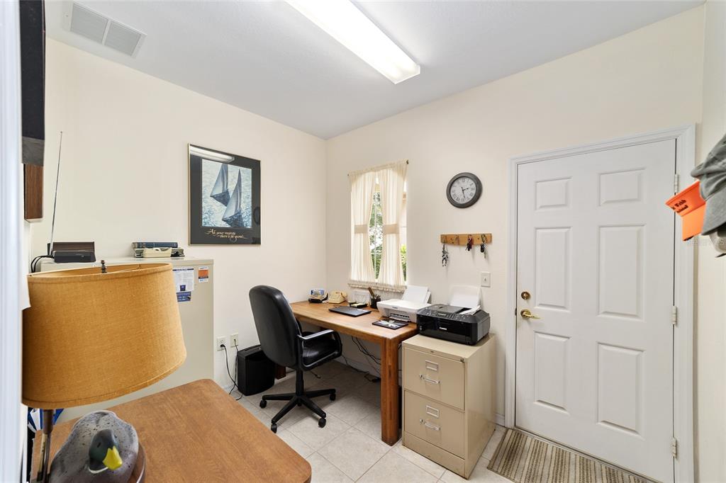 12896 Southeast 91st Terrace Road Summerfield, FL 34491 - Photo 36 of 77 a view of a workspace with furniture and a window