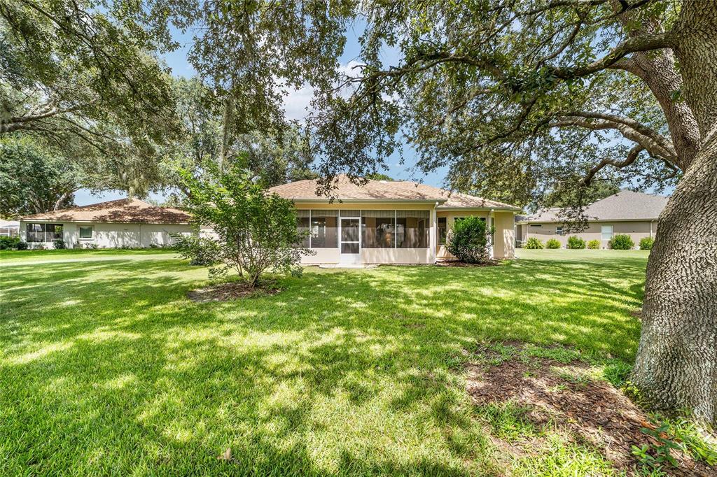 12896 Southeast 91st Terrace Road Summerfield, FL 34491 - Photo 43 of 77 a front view of a house with a garden
