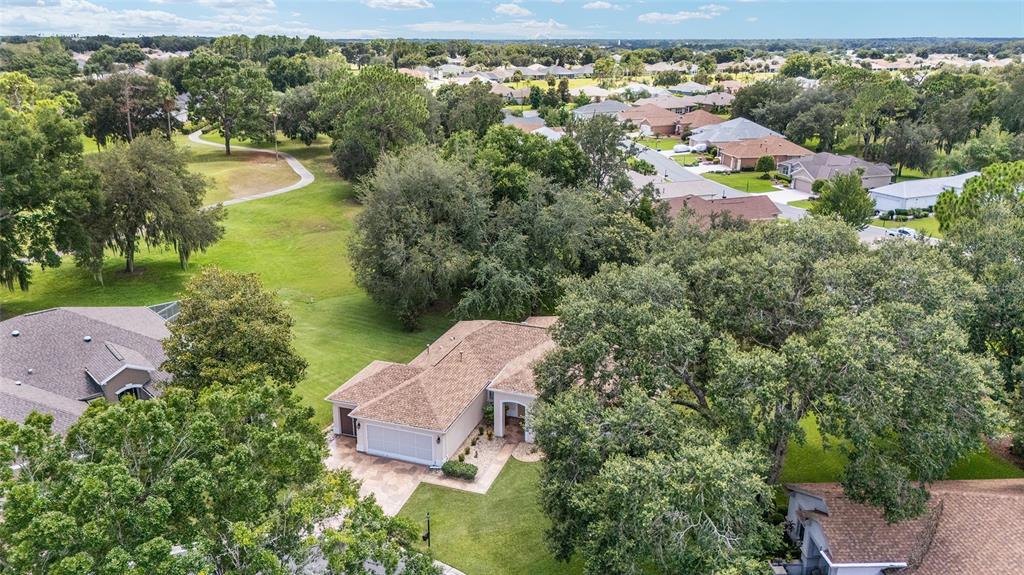 12896 Southeast 91st Terrace Road Summerfield, FL 34491 - Photo 47 of 77 an aerial view of residential house with outdoor space and lake view