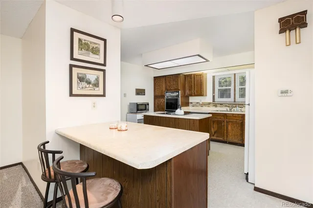 a kitchen with a stove a sink and a microwave