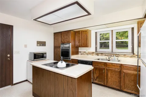 a kitchen with a table and chairs