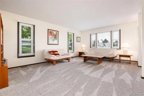 a view of a dining room with furniture and window