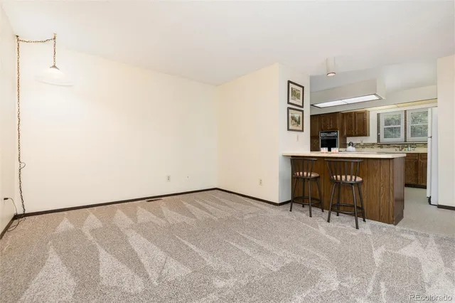 a view of a room with furniture and a kitchen