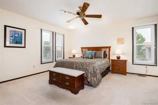 a spacious bedroom with a bed and a chandelier