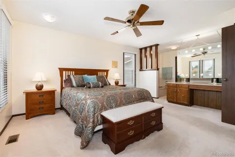 a bedroom with a bed and a lamp