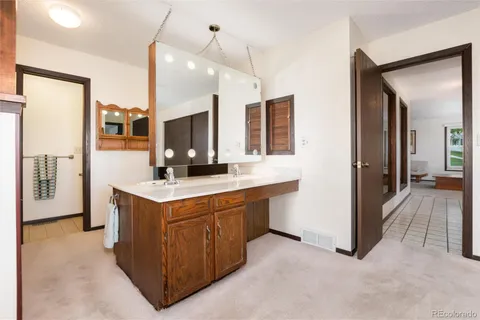 a bathroom with a tub sink and mirror