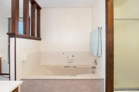 a spacious bedroom with a bed and a ceiling fan