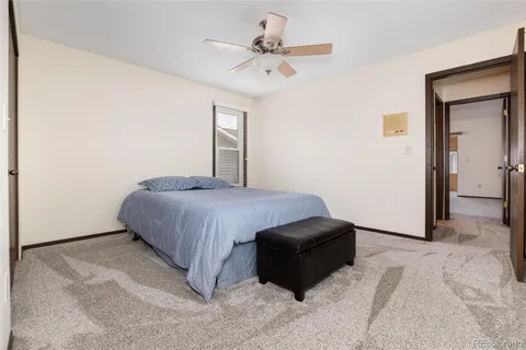 a spacious bedroom with a bed and a chandelier