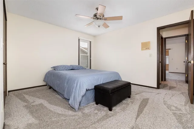 a spacious bedroom with a bed and a chandelier