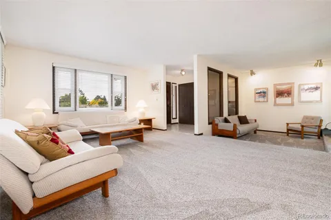 a living room with furniture and large windows