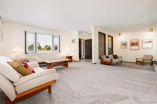 a living room with furniture and large windows