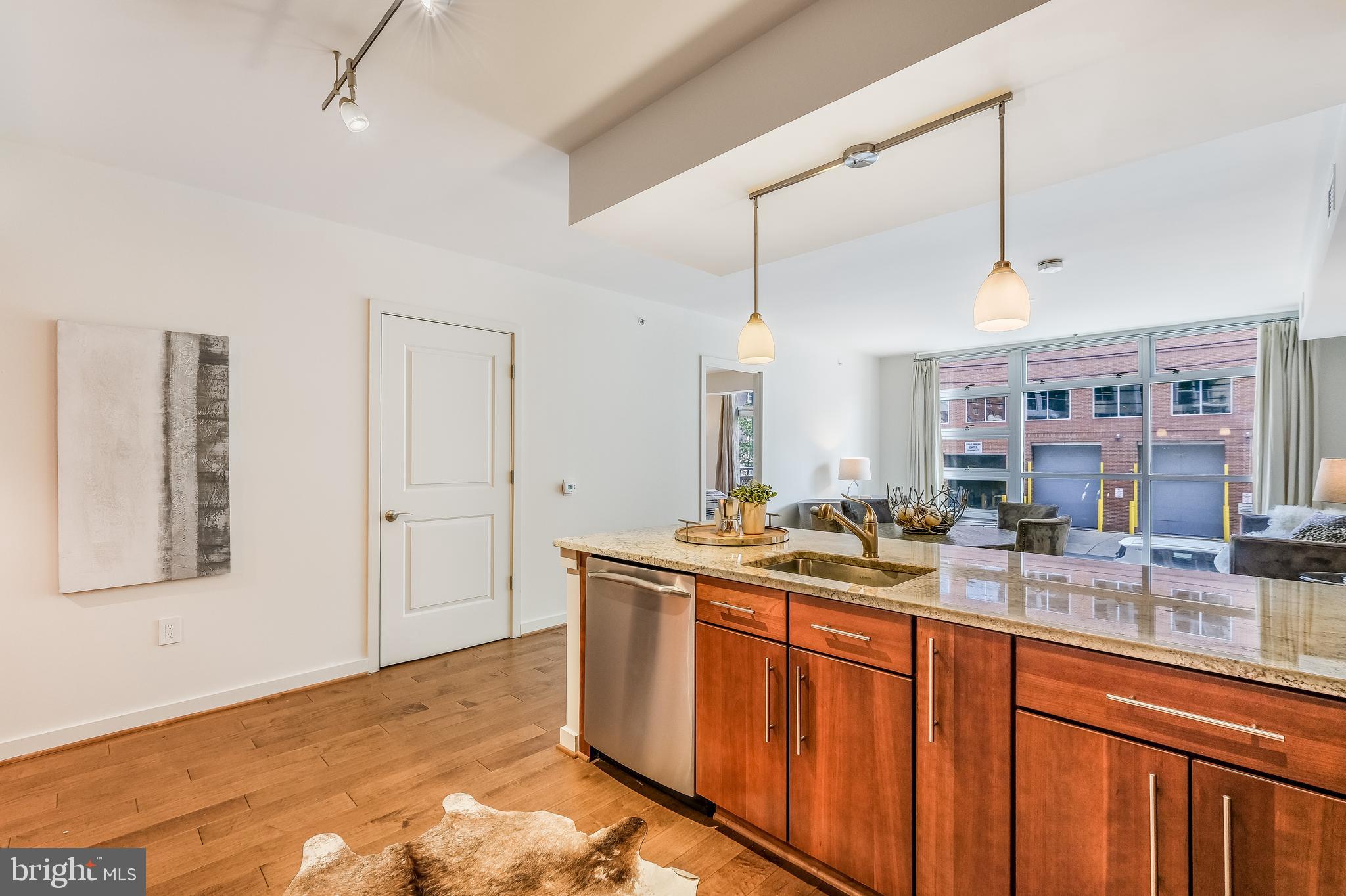 1025 First Street Southeast, Unit 201 Washington, DC 20003 - Photo 11 of 31 a kitchen with stainless steel appliances granite countertop a sink and a stove
