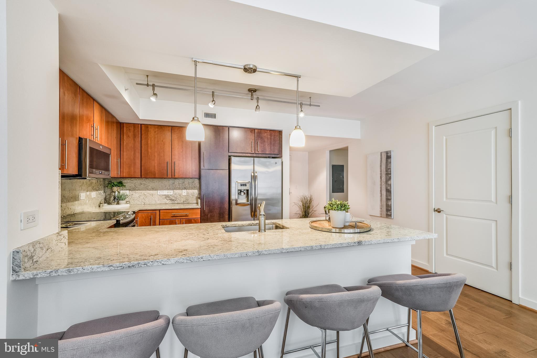 1025 First Street Southeast, Unit 201 Washington, DC 20003 - Photo 13 of 31 a large kitchen with a table and chairs in it