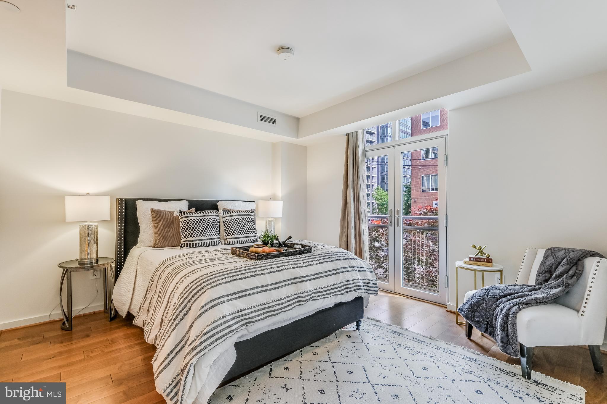 1025 First Street Southeast, Unit 201 Washington, DC 20003 - Photo 14 of 31 a bedroom with bed and balcony