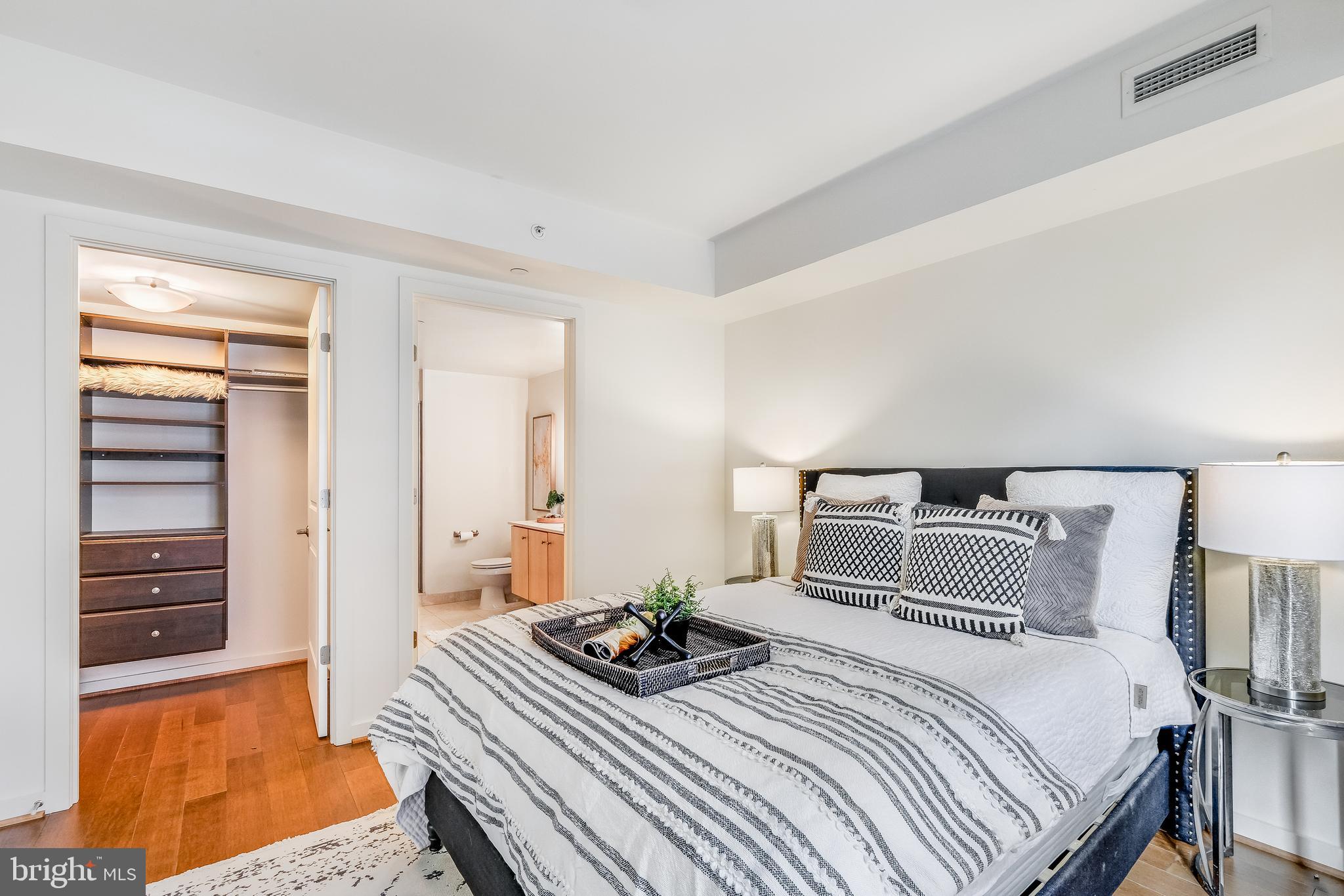 1025 First Street Southeast, Unit 201 Washington, DC 20003 - Photo 16 of 31 a bedroom with a bed and wooden floor