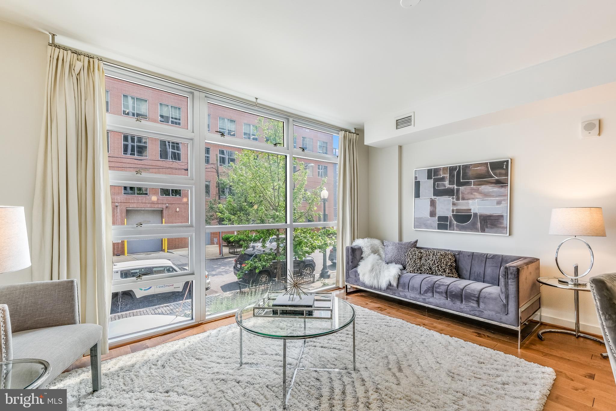 1025 First Street Southeast, Unit 201 Washington, DC 20003 - Photo 4 of 31 a living room with furniture and a large window