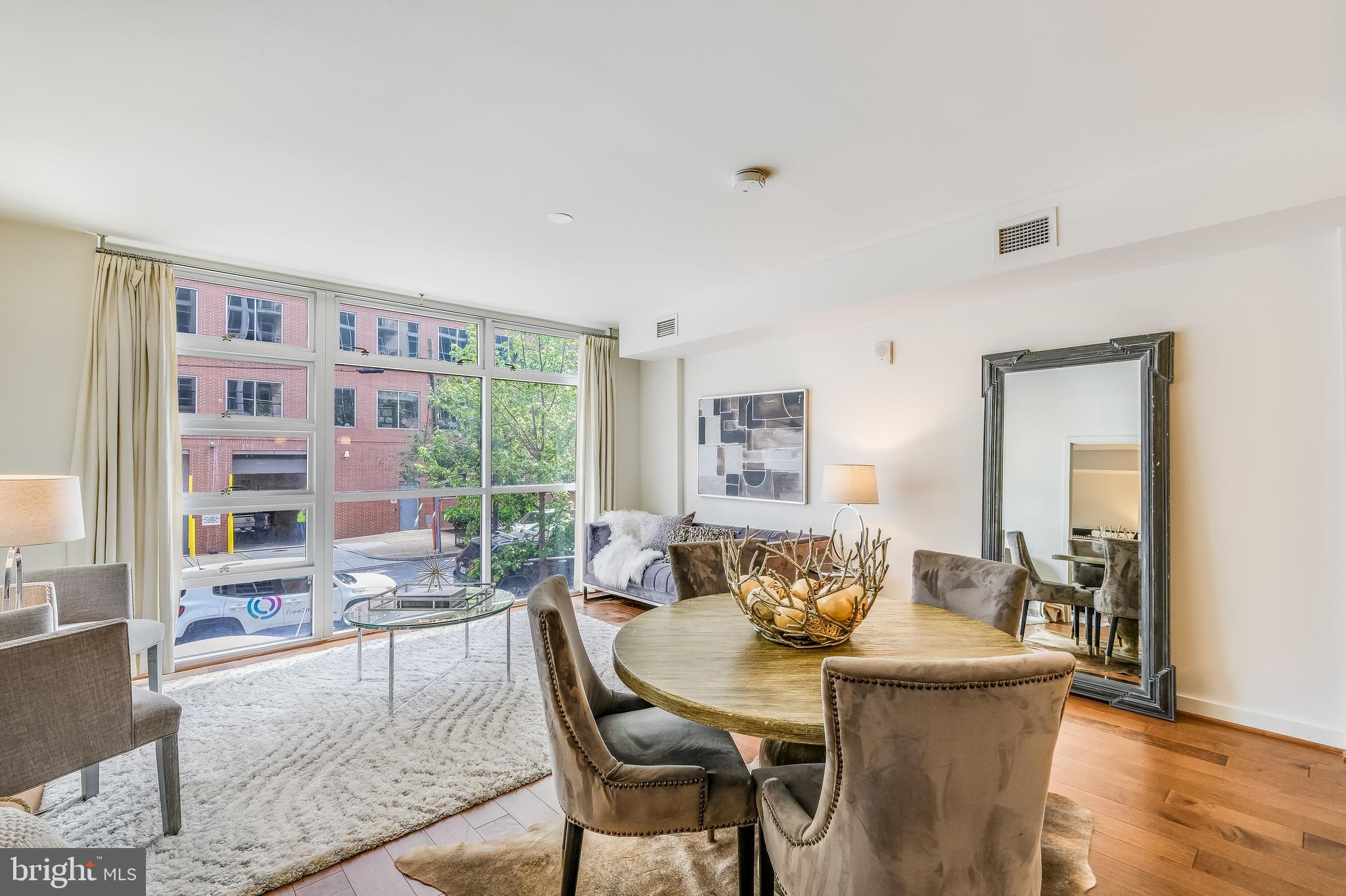 1025 First Street Southeast, Unit 201 Washington, DC 20003 - Photo 5 of 31 a view of a dining room with furniture window and wooden floor