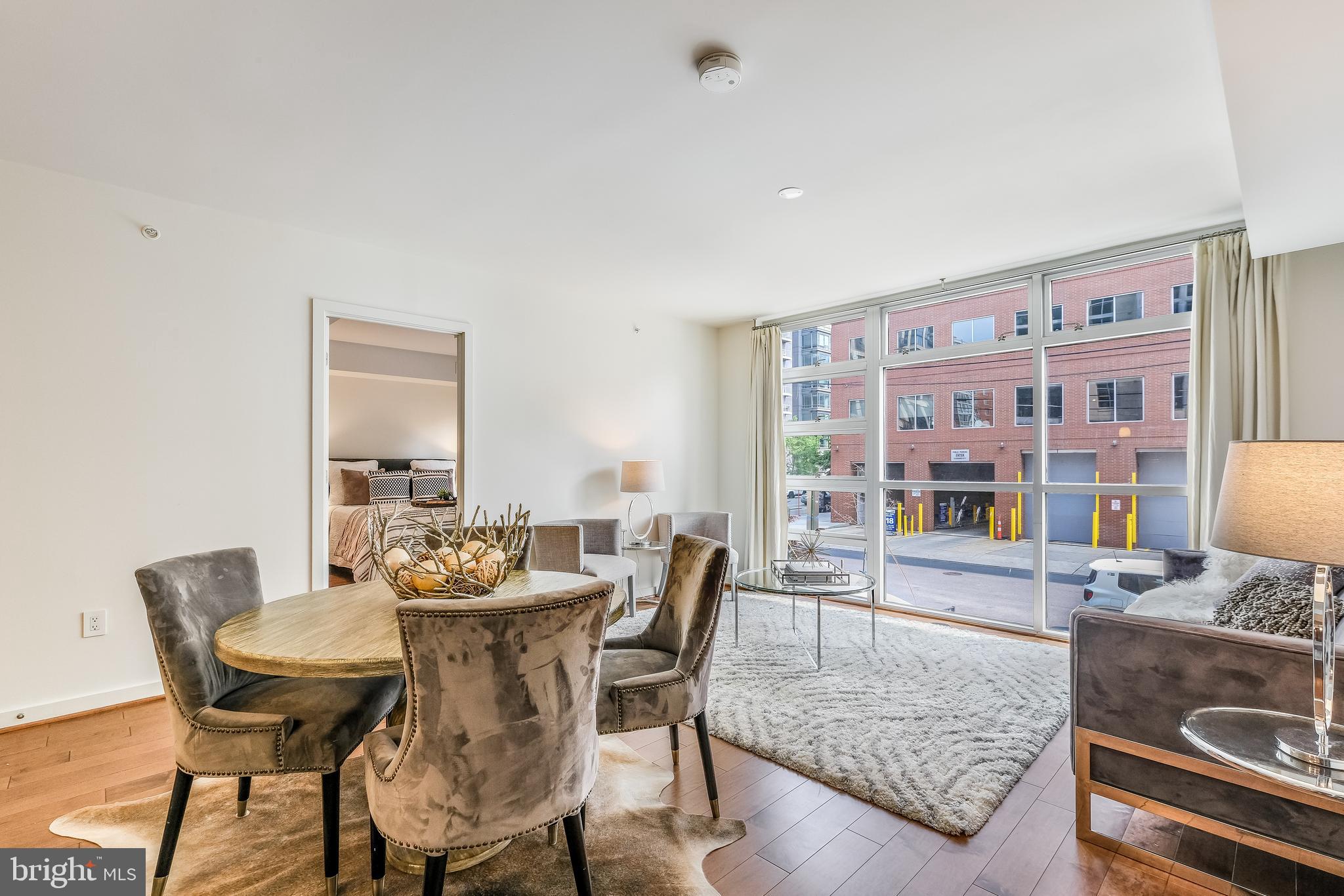 1025 First Street Southeast, Unit 201 Washington, DC 20003 - Photo 6 of 31 a view of a dining room with furniture and wooden floor
