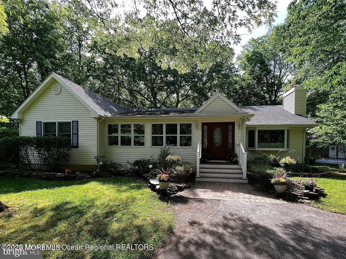 a front view of a house with a garden