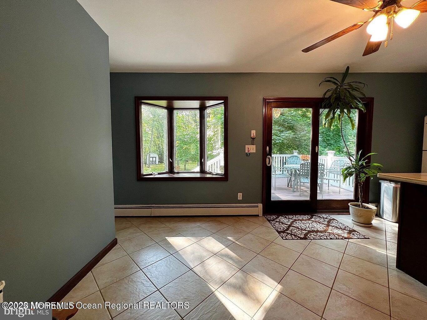 a view of an empty room with a fireplace and a window