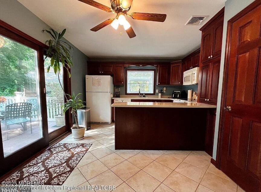 791 Harmony Road Jackson, NJ 08527 - Photo 3 of 16 a kitchen with kitchen island granite countertop a refrigerator a sink dishwasher and wooden cabinets