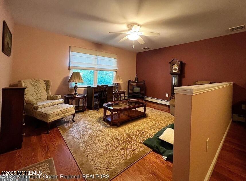 791 Harmony Road Jackson, NJ 08527 - Photo 5 of 16 a living room with furniture and a chandelier