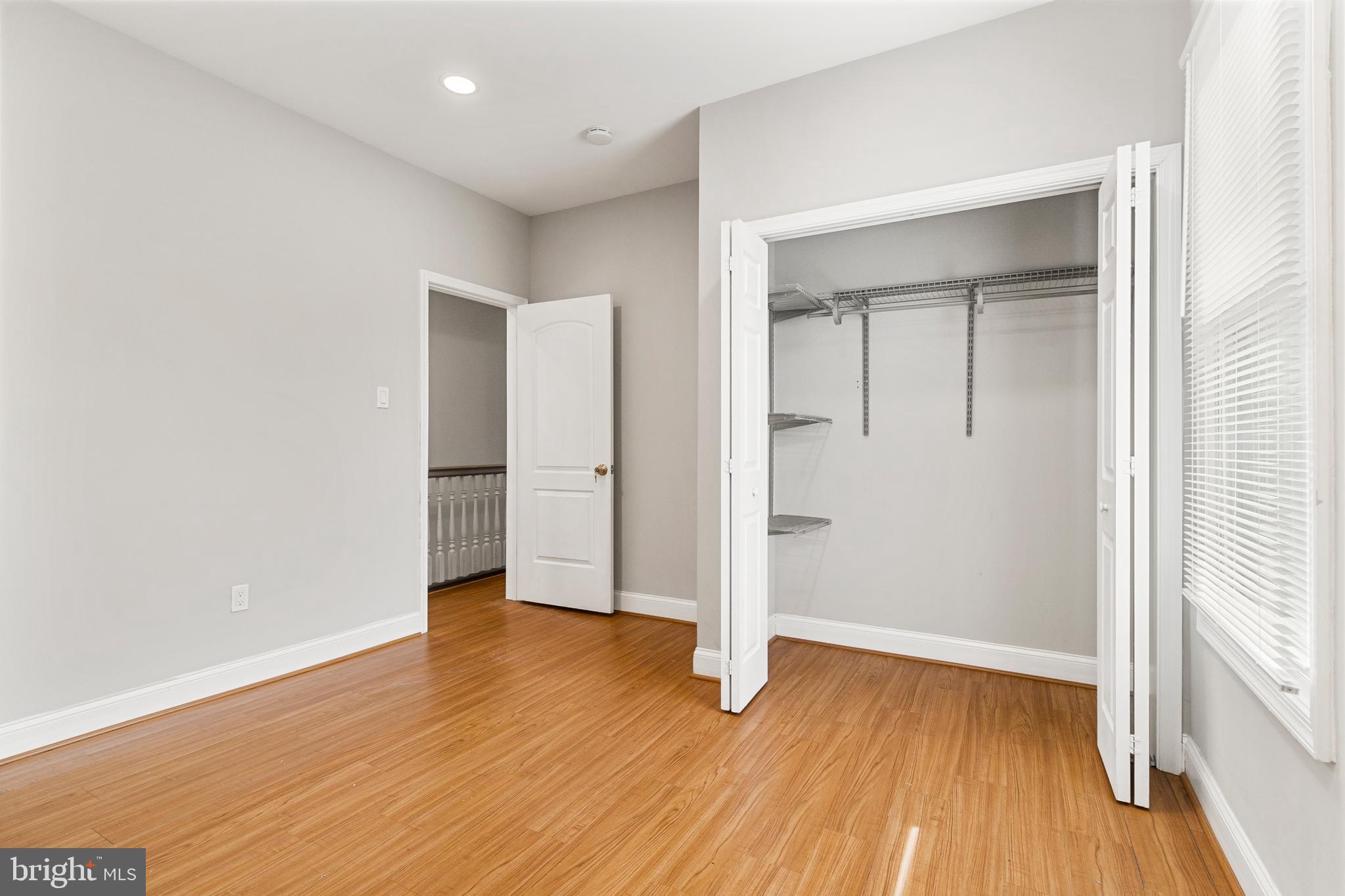 910 Savannah Street Southeast Washington, DC 20032 - Photo 18 of 26 an empty room with wooden floor & closet area