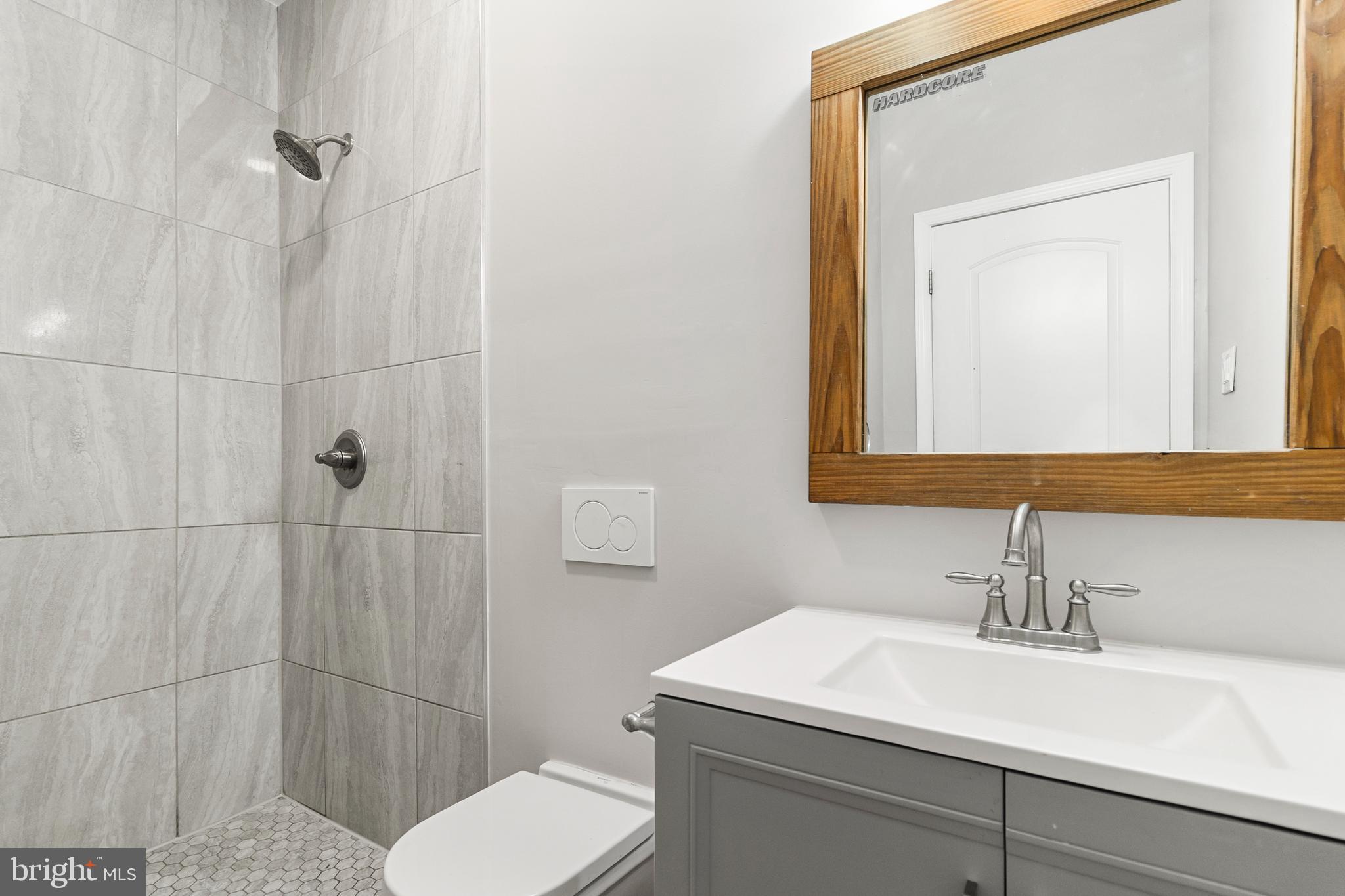 910 Savannah Street Southeast Washington, DC 20032 - Photo 19 of 26 a bathroom with a sink a toilet and shower