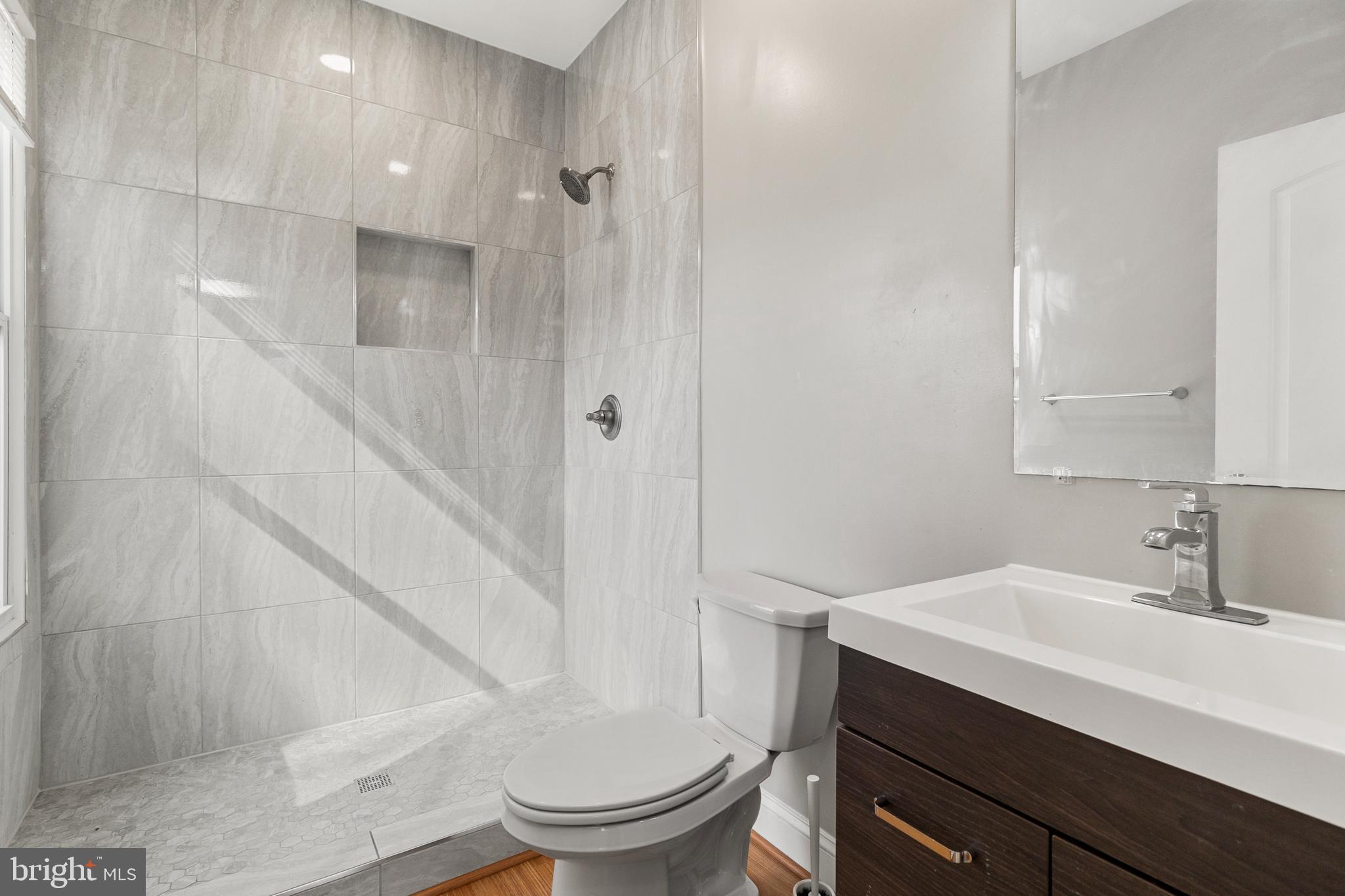 910 Savannah Street Southeast Washington, DC 20032 - Photo 22 of 26 a bathroom with a sink a toilet and shower