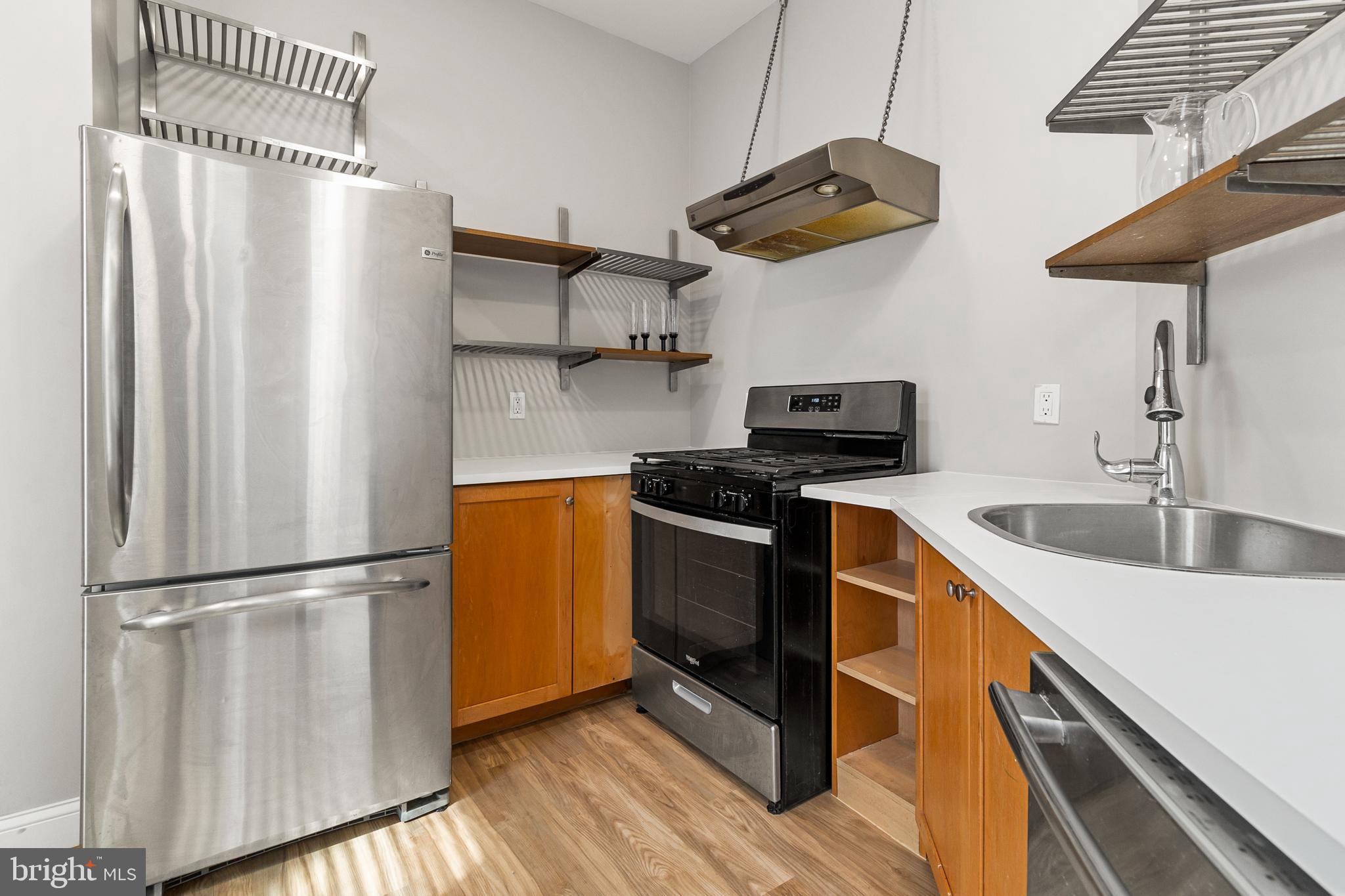 910 Savannah Street Southeast Washington, DC 20032 - Photo 6 of 26 a kitchen with stainless steel appliances granite countertop a sink a stove a refrigerator and cabinets