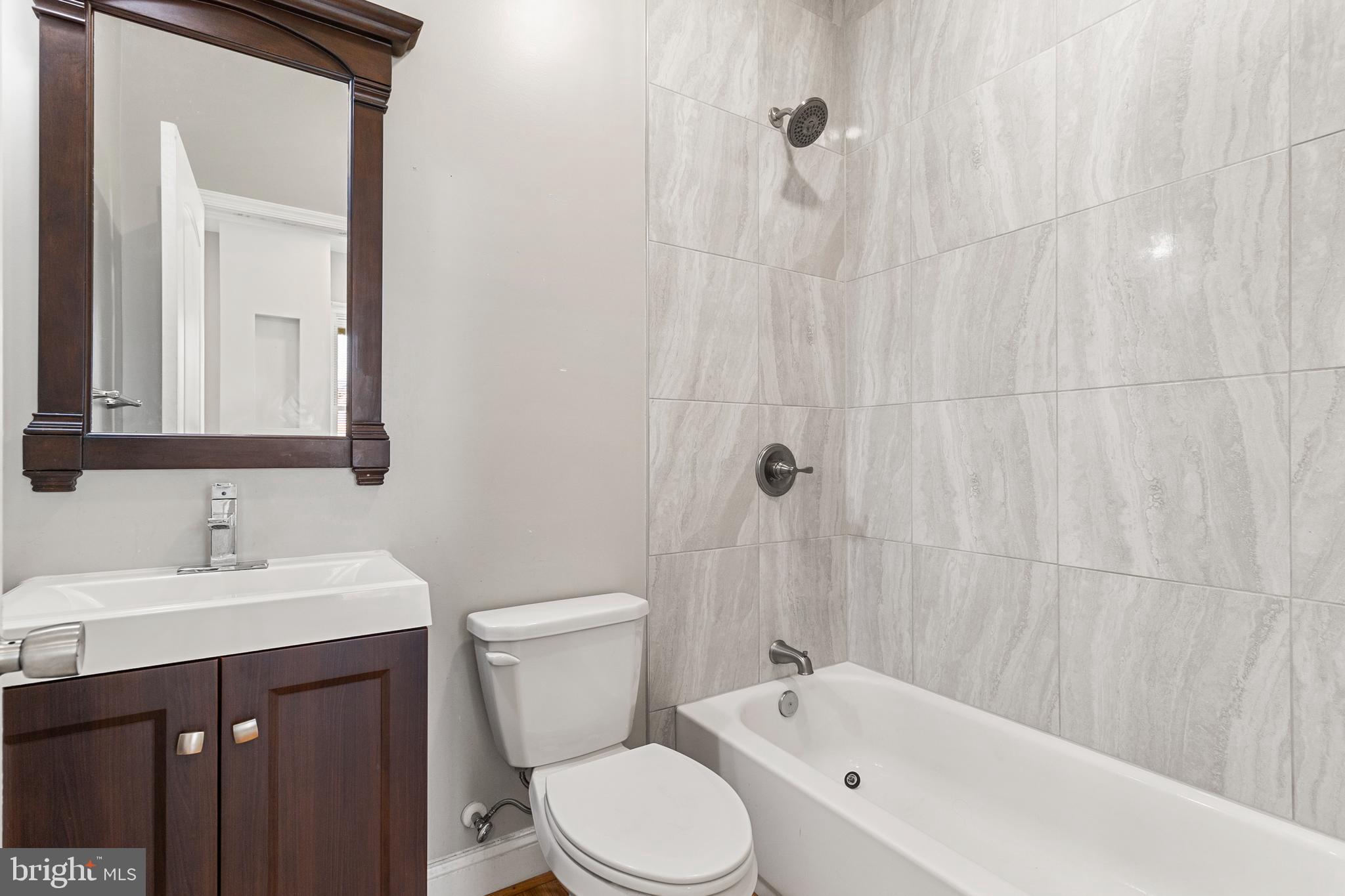 910 Savannah Street Southeast Washington, DC 20032 - Photo 9 of 26 a bathroom with a sink a toilet and shower