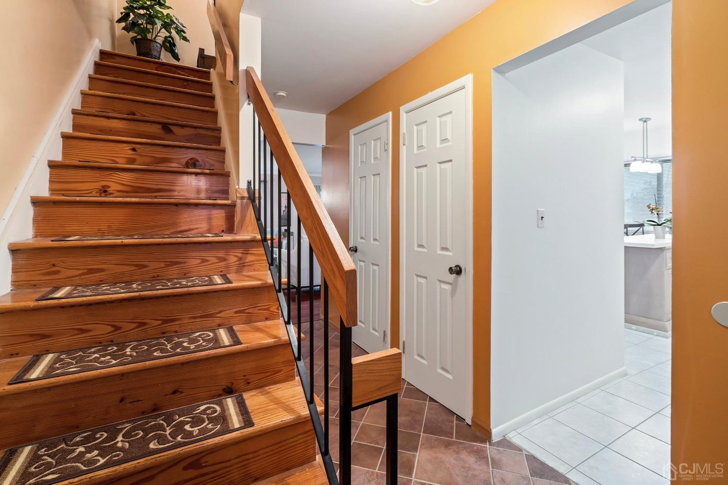 a view of entryway with wooden floor and stairs