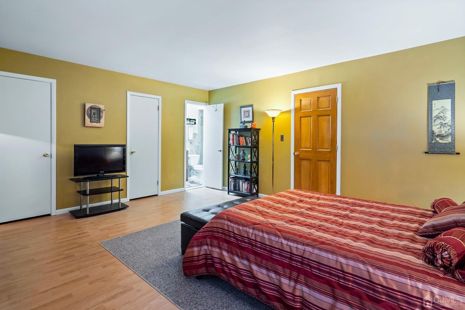 606 Robin Road Hillsborough, NJ 08844 - Photo 13 of 20 a bedroom with a bed and a flat screen tv