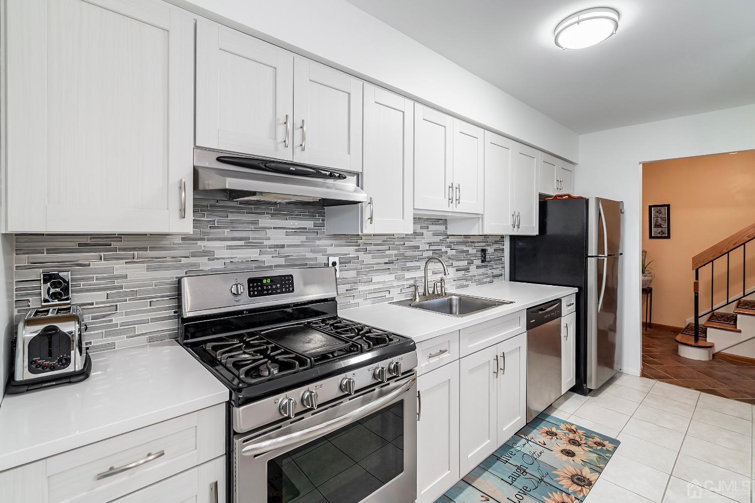 606 Robin Road Hillsborough, NJ 08844 - Photo 4 of 20 a kitchen with stainless steel appliances granite countertop a stove a refrigerator and a white cabinets