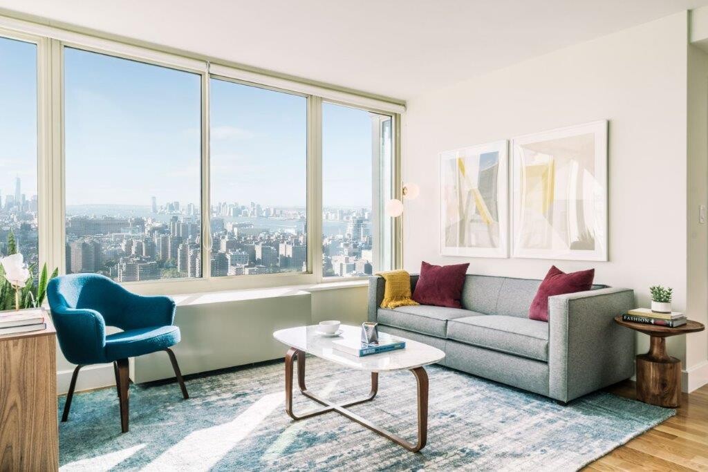 a living room with furniture and a large window