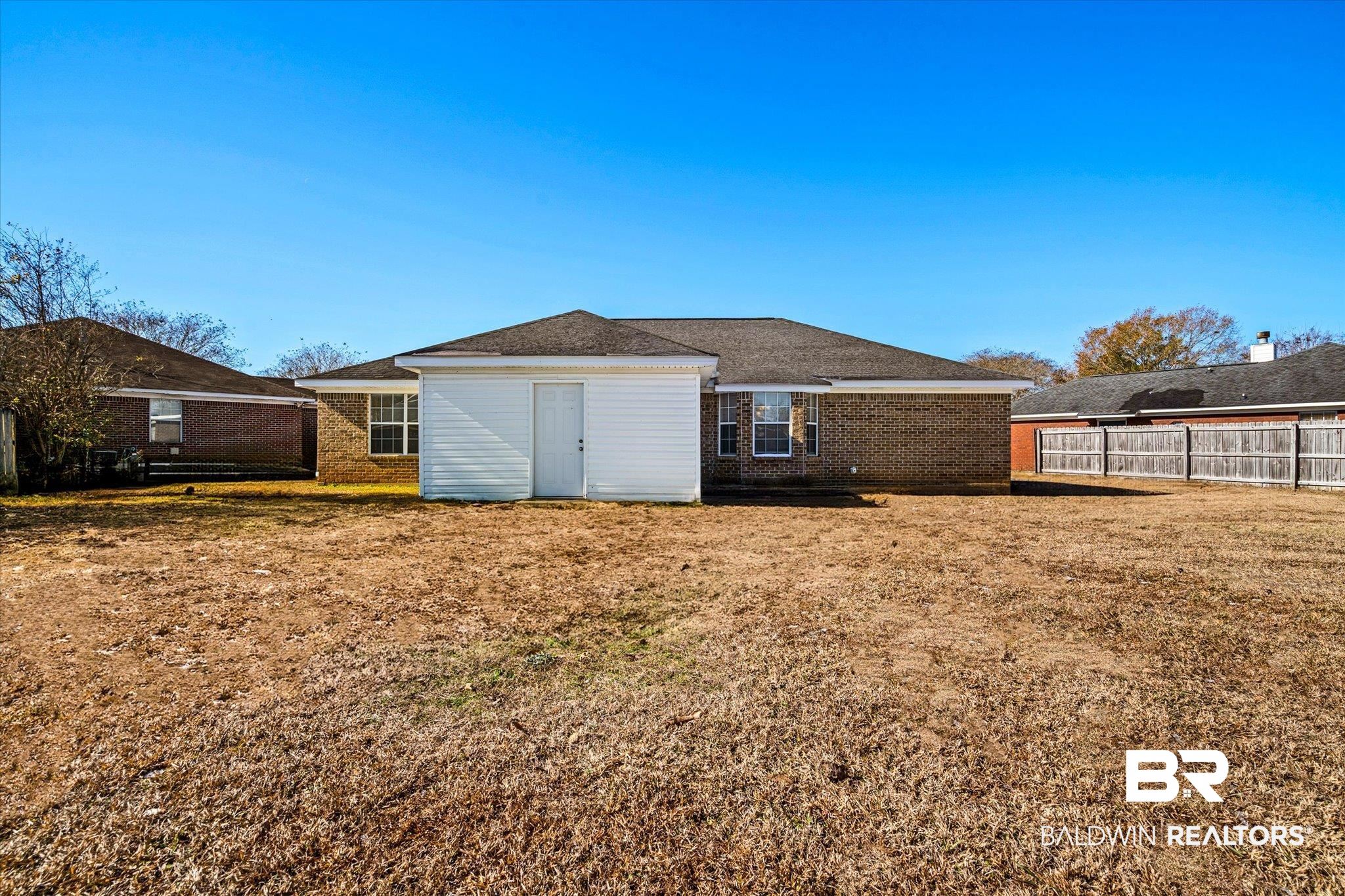 8374 Kipling Court Mobile, AL 36695 - Photo 18 of 20 Rear view of house featuring a yard