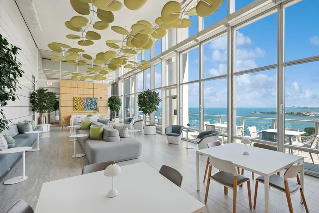 a living room with fireplace furniture and a large window