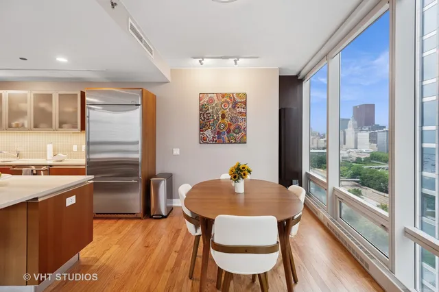 a kitchen with a table chairs and refrigerator
