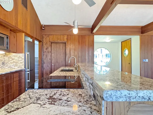 a kitchen that has a sink and a stove