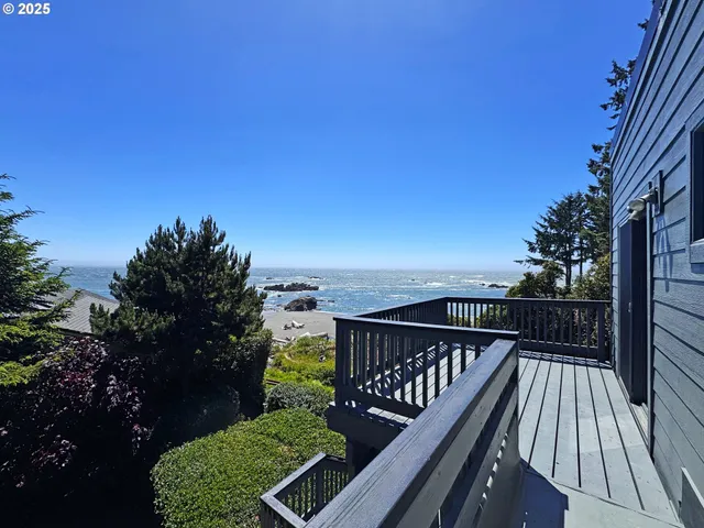 a balcony with wooden floor and city view