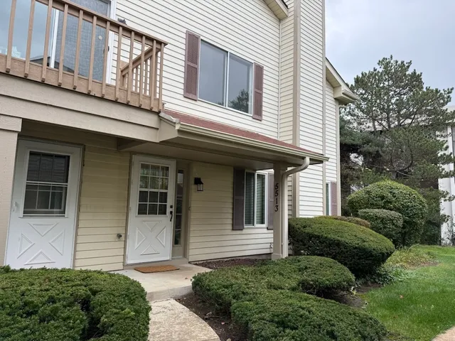 a view of a house with a small yard and plants