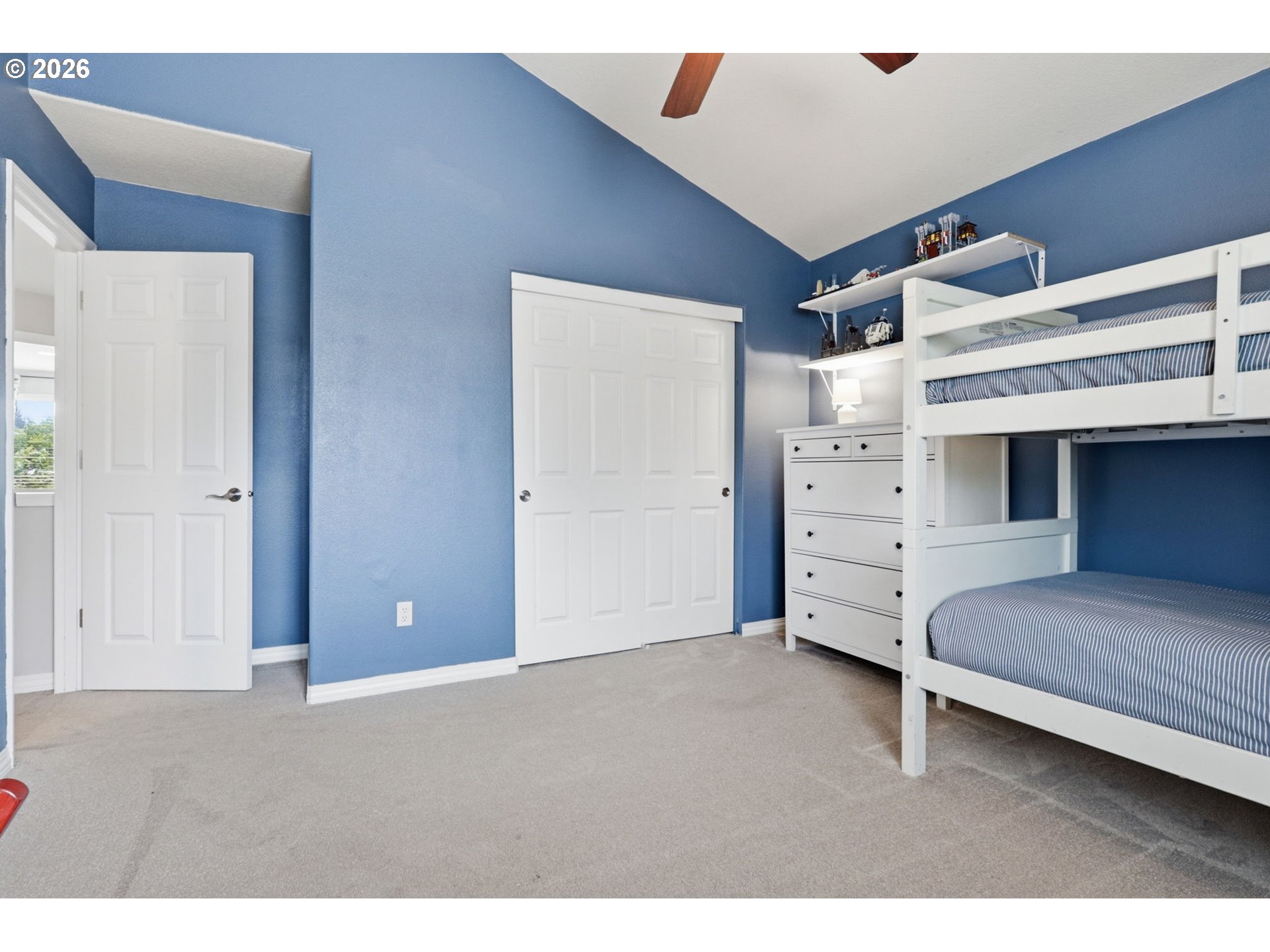 3306 Solstice Lane Newberg, OR 97132 - Photo 27 of 47 a room with a bed and a ceiling fan