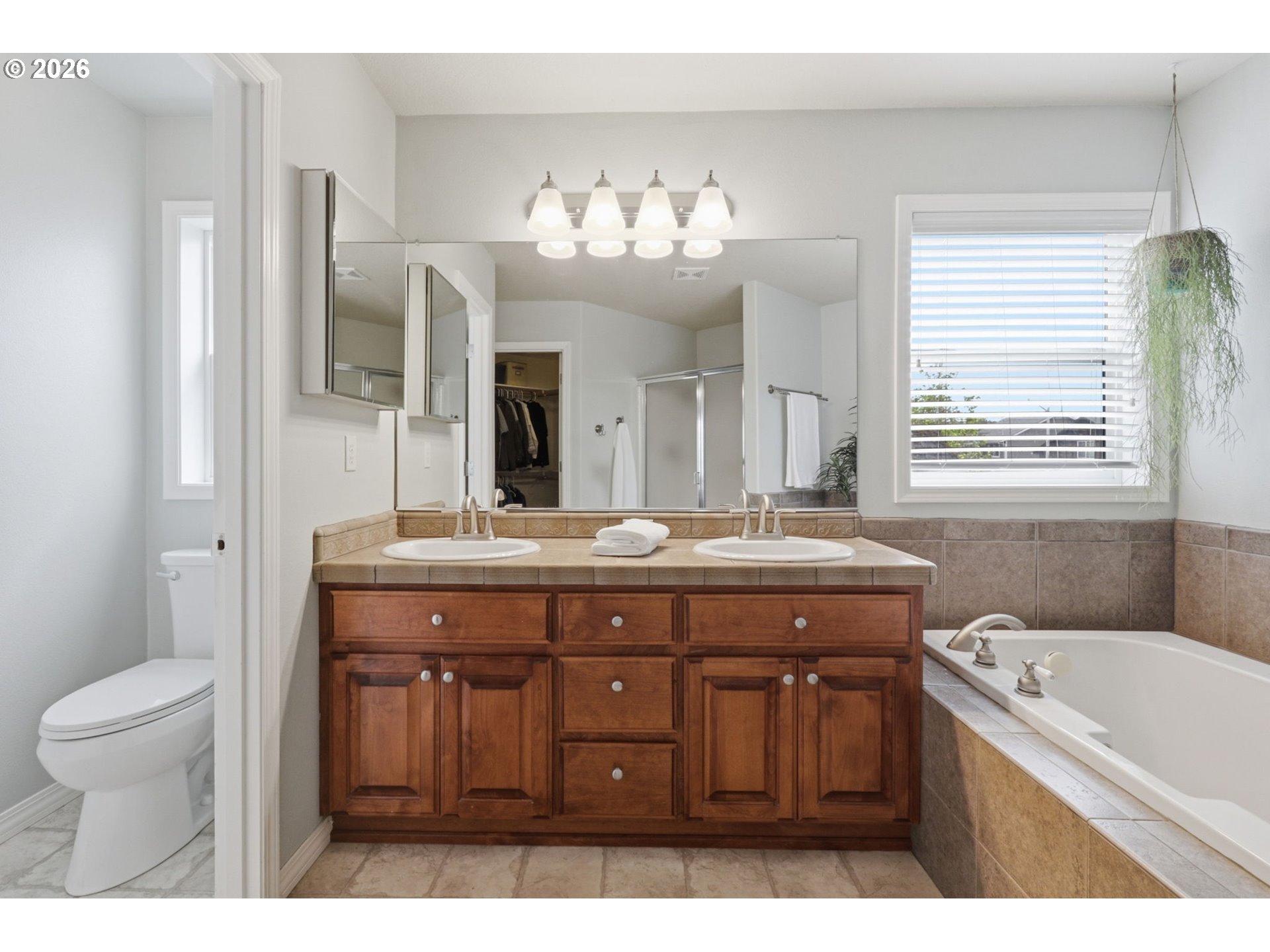 3306 Solstice Lane Newberg, OR 97132 - Photo 35 of 47 a bathroom with a granite countertop sink a large mirror a toilet and a bathtub