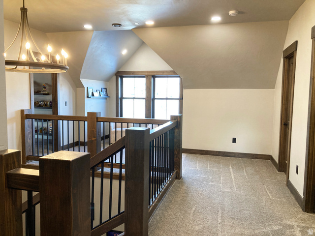 259 Meadow Drive Springville, UT 84663 - Photo 31 of 62 Hallway with light colored carpet, vaulted ceiling, an upstairs landing, and suspended lighting