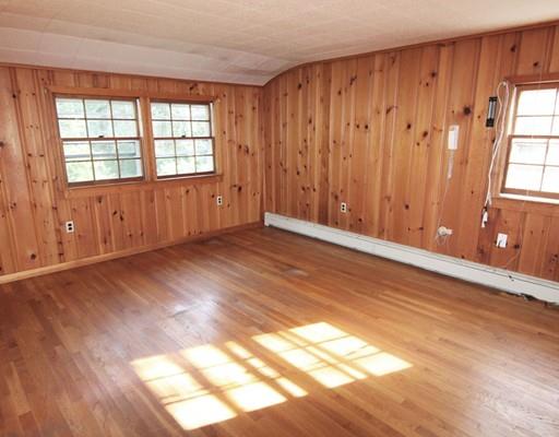 31 Dudley Road Billerica, MA 01821 - Photo 11 of 20 an empty room with wooden floor and windows with curtains