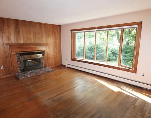 31 Dudley Road Billerica, MA 01821 - Photo 4 of 20 a view of empty room with wooden floor and fireplace
