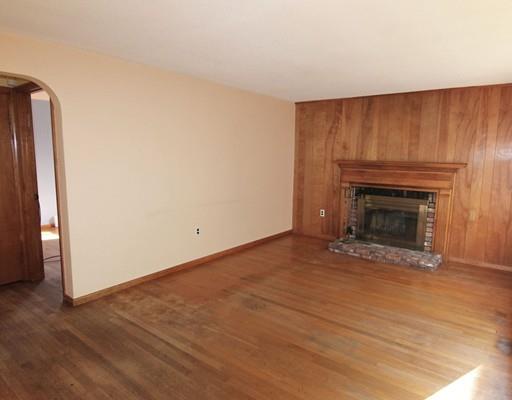 31 Dudley Road Billerica, MA 01821 - Photo 5 of 20 a view of empty room with wooden floor and fireplace
