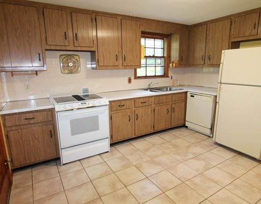 31 Dudley Road Billerica, MA 01821 - Photo 7 of 20 a kitchen with a stove sink and refrigerator