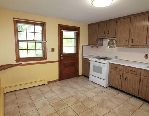 31 Dudley Road Billerica, MA 01821 - Photo 8 of 20 a kitchen with stainless steel appliances granite countertop a stove a sink and a refrigerator